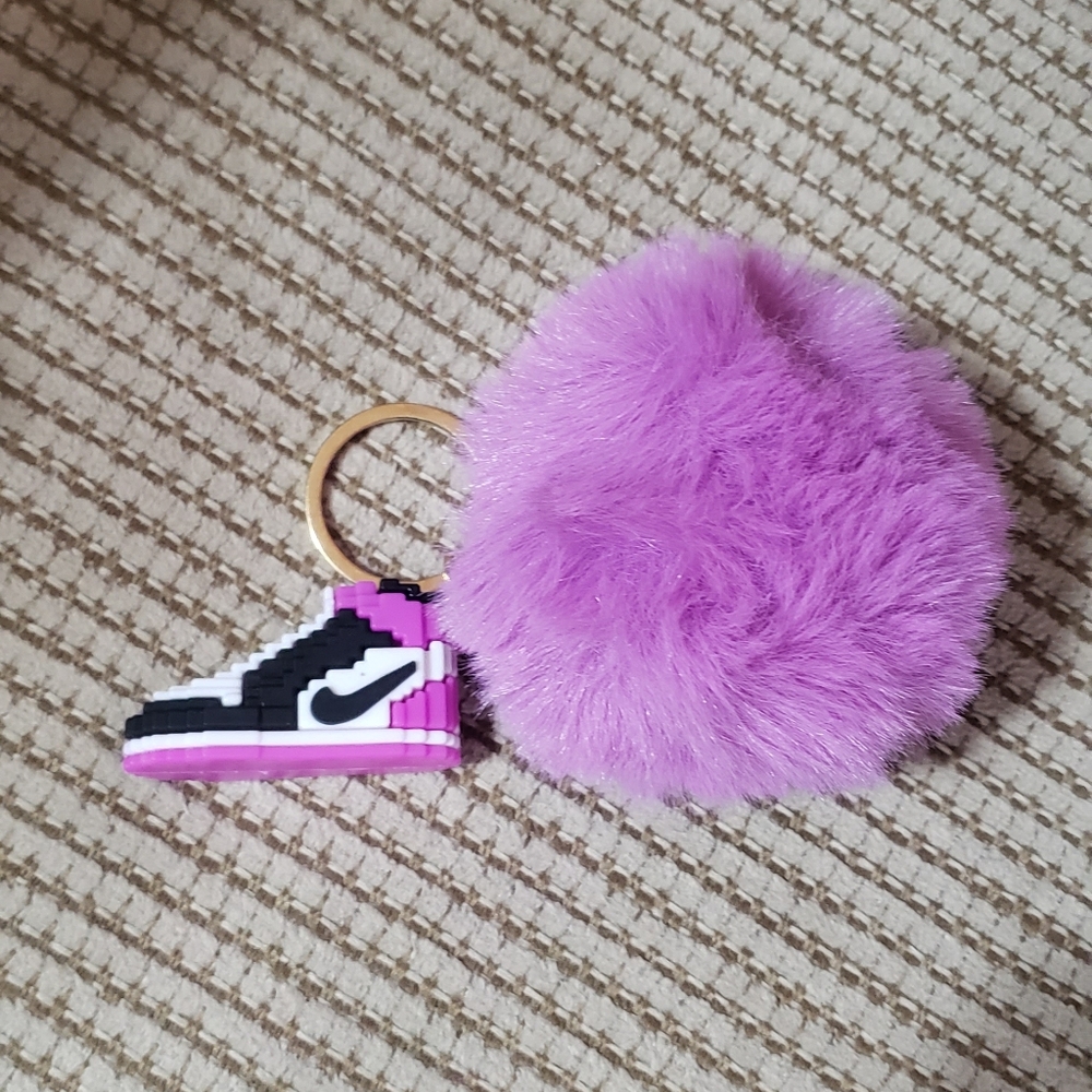 Faux Fur Pom Pom Keychain Featuring a Block-Style Nike Air Jordan Sneaker Charm.